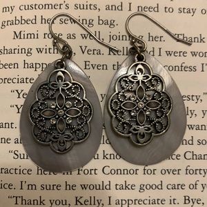Grey teardrop earrings with intricate swirls overlaid